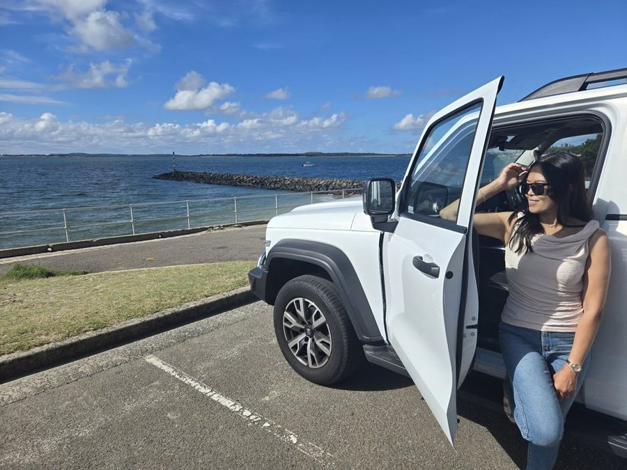 Chantelle leaning on the car by the water